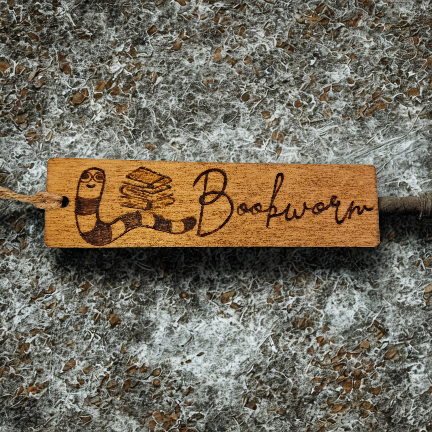 Dark wood bookmark with "Bookworm" pyrography and a worm and stack of books illustration.