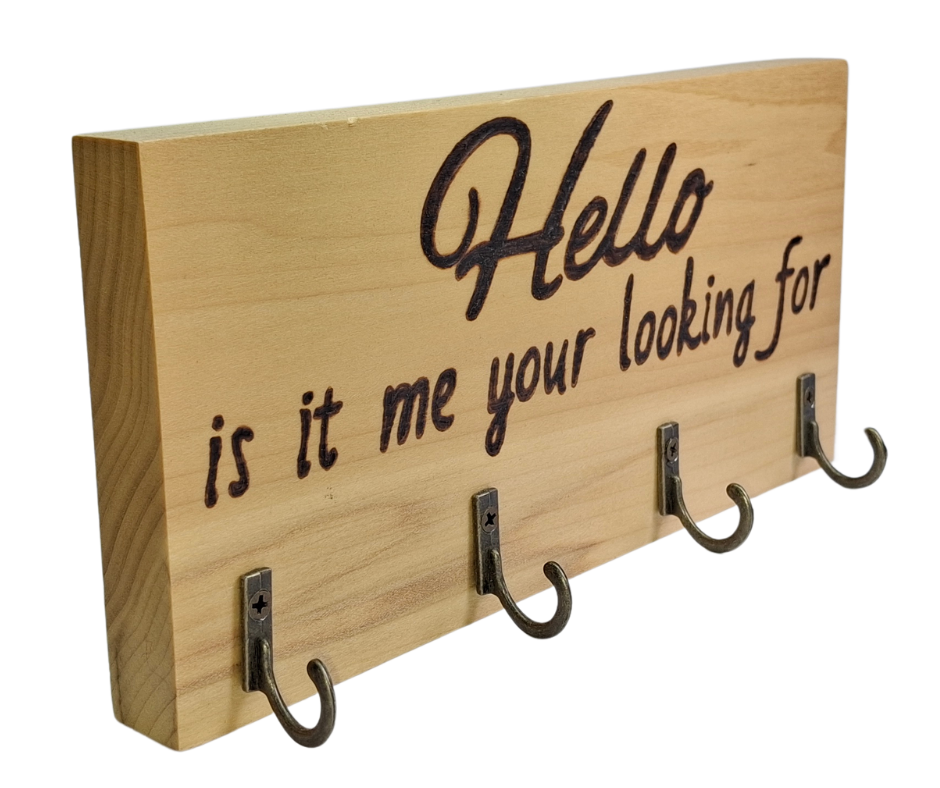 A four-hook hanger crafted from two-tone Tulipwood, featuring hand-burnt lettering that reads "Hello, Is It Me You're Looking For?" The wood has visible grain, showcasing its natural variations.