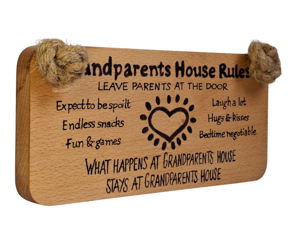 Hand-decorated pyrography sign for grandparents, featuring "Grandparents House Rules" and playful guidelines such as "Leave parents at the door," suspended by a sturdy jute rope.