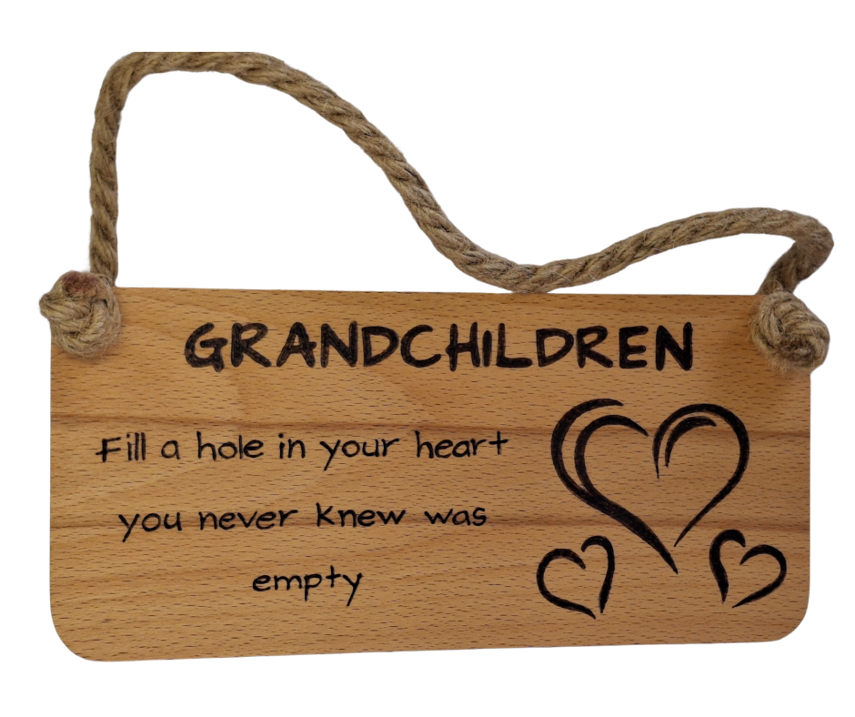 Wooden plaque hand-burnt with "Grandchildren fill a hole in your heart you never knew was empty" pyrography and three heart illustrations, hung by a thick jute rope.