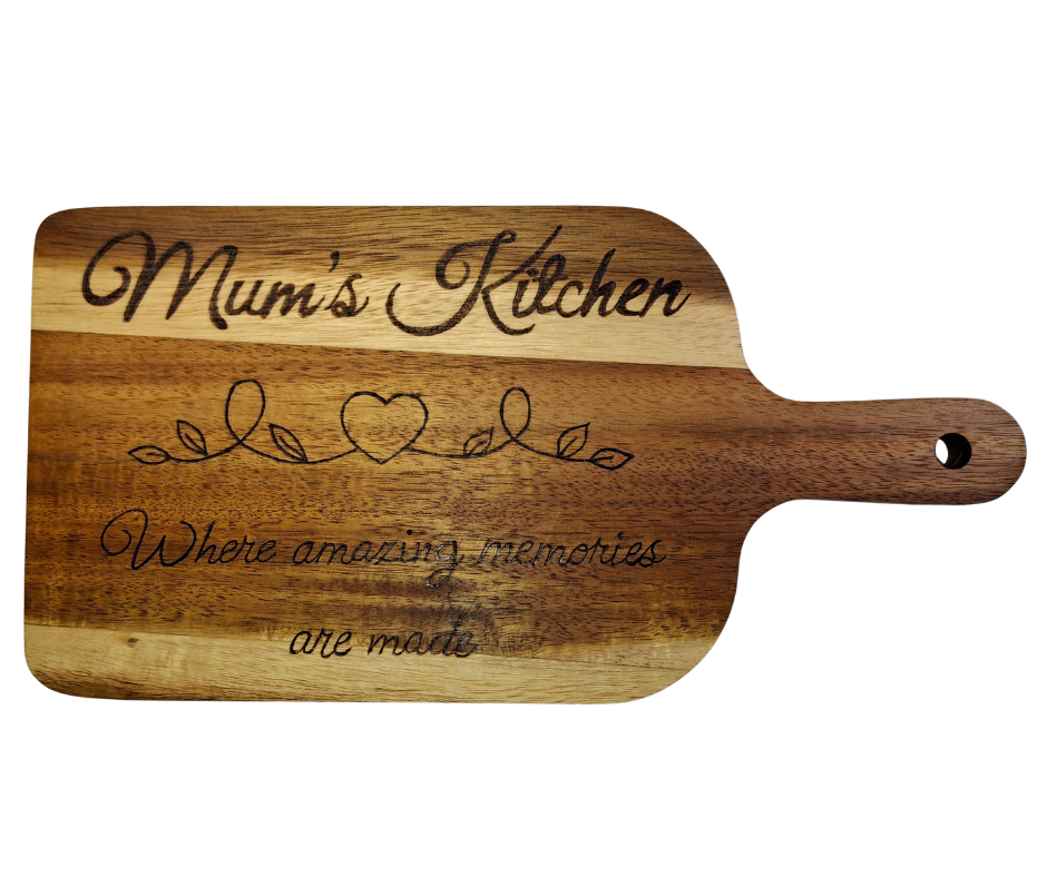 A multicolored, hand-decorated pyrography chopping board with the words "Mum's Kitchen where amazing memories are made" and a heart divider.