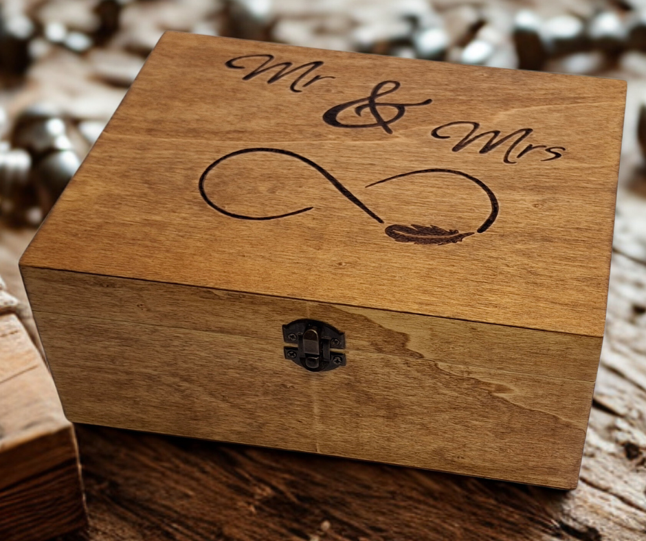 "Mr and Mrs" hand-burnt onto a wooden box top, featuring an infinity symbol and a delicate feather