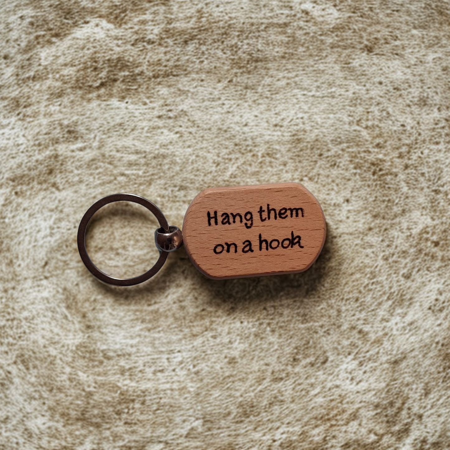 Oval beechwood keyring with 'Hang them on a hook' pyrography text and chrome split ring