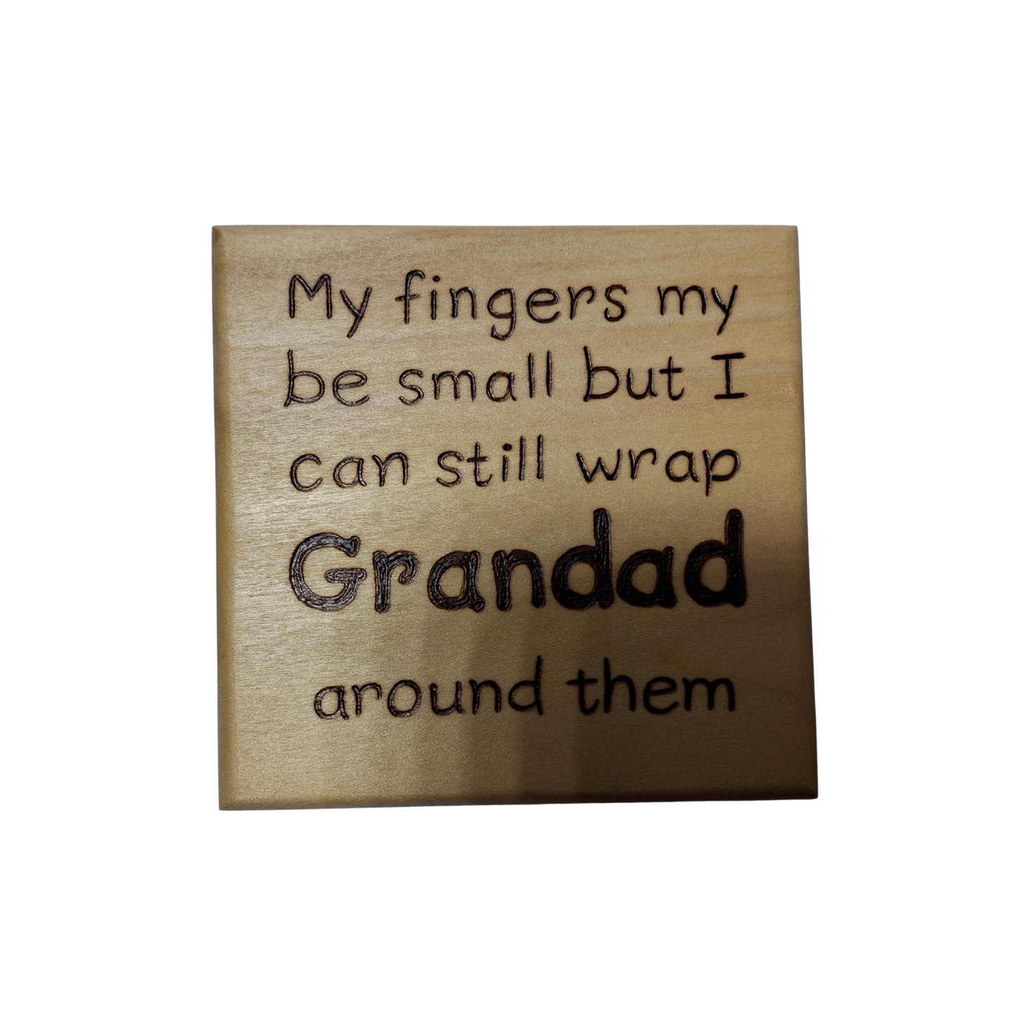 A light wood coaster, square in shape, with pyrography lettering. The text reads: "My fingers my be small but I can still wrap Grandad around them". The word "Grandad" is significantly larger and bolder than the rest of the text.