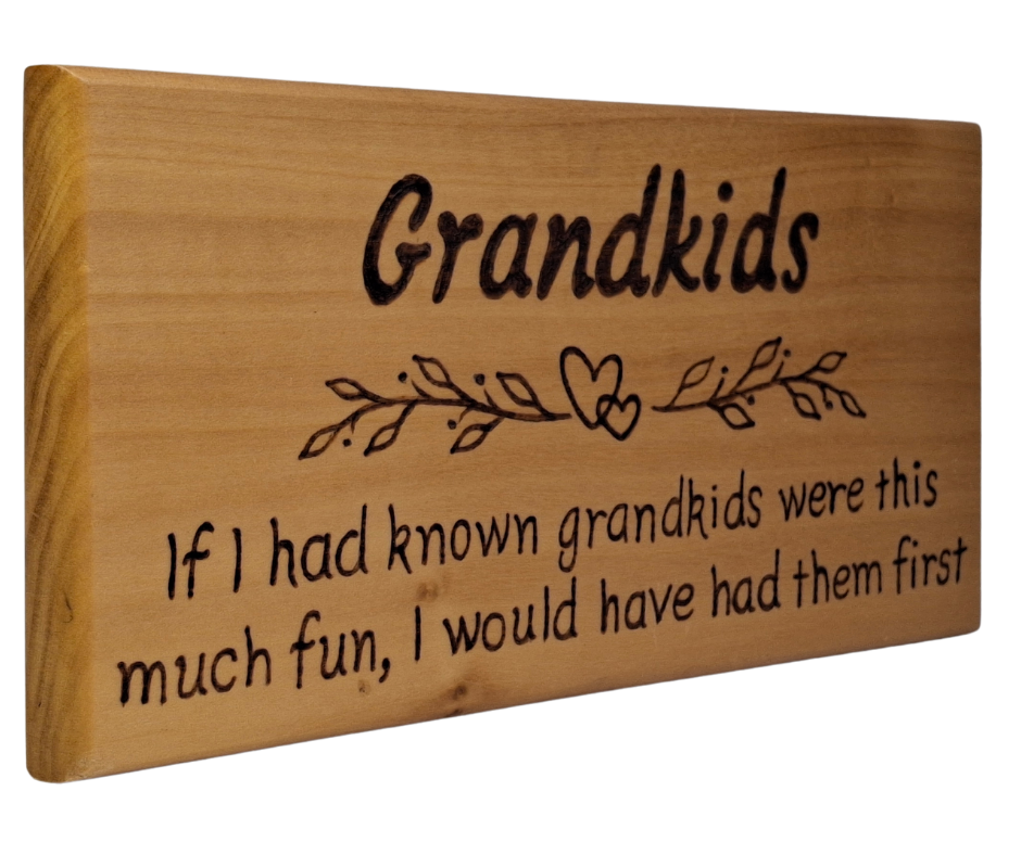 Wooden plaque hand-decorated with "Grandkids" heading, a heart and leaf border, and the humorous pyrography verse "If I had known grandkids were this much fun I would have had them first."