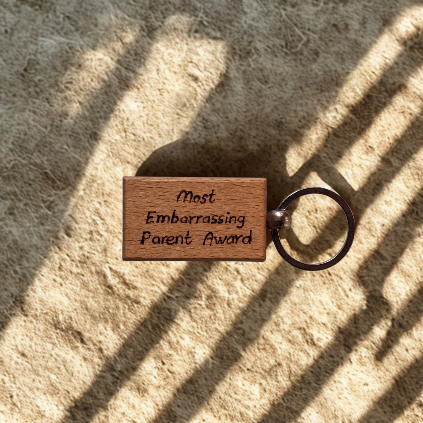 Rectangle beechwood keyring with 'Most Embarrassing Parent Award' pyrography text and chrome split ring"
