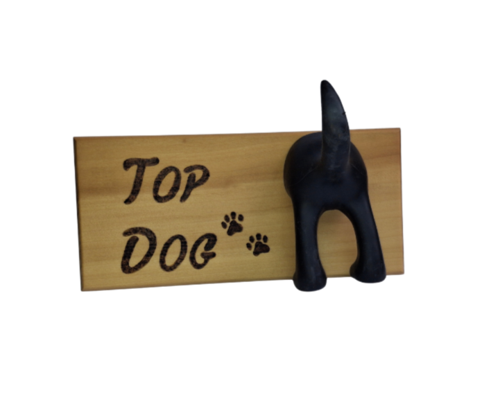 A hand-burnt wooden plaque with the words "Top Dog" and two paw prints, featuring a unique rubber dog bum and tail for hanging leads. The plaque has a rustic, natural finish, highlighting the visible wood grain.