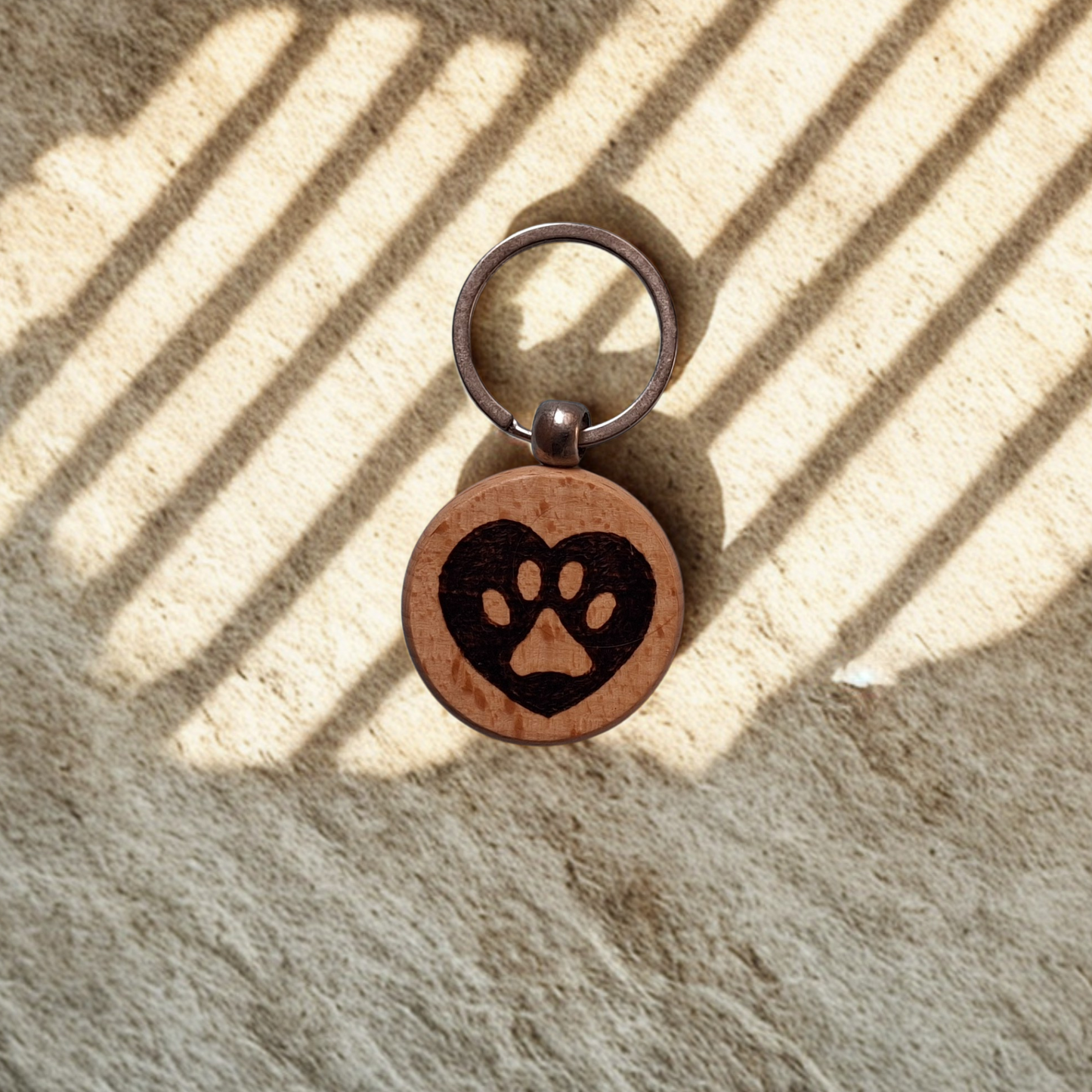 Round beechwood keyring with heart-shaped paw print pyrography design and chrome split ring