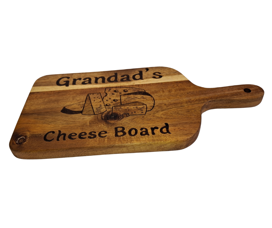 A multicolored, hand-decorated pyrography chopping board with the words "Grandad's Cheese Board" and illustrations of cheese chunks.