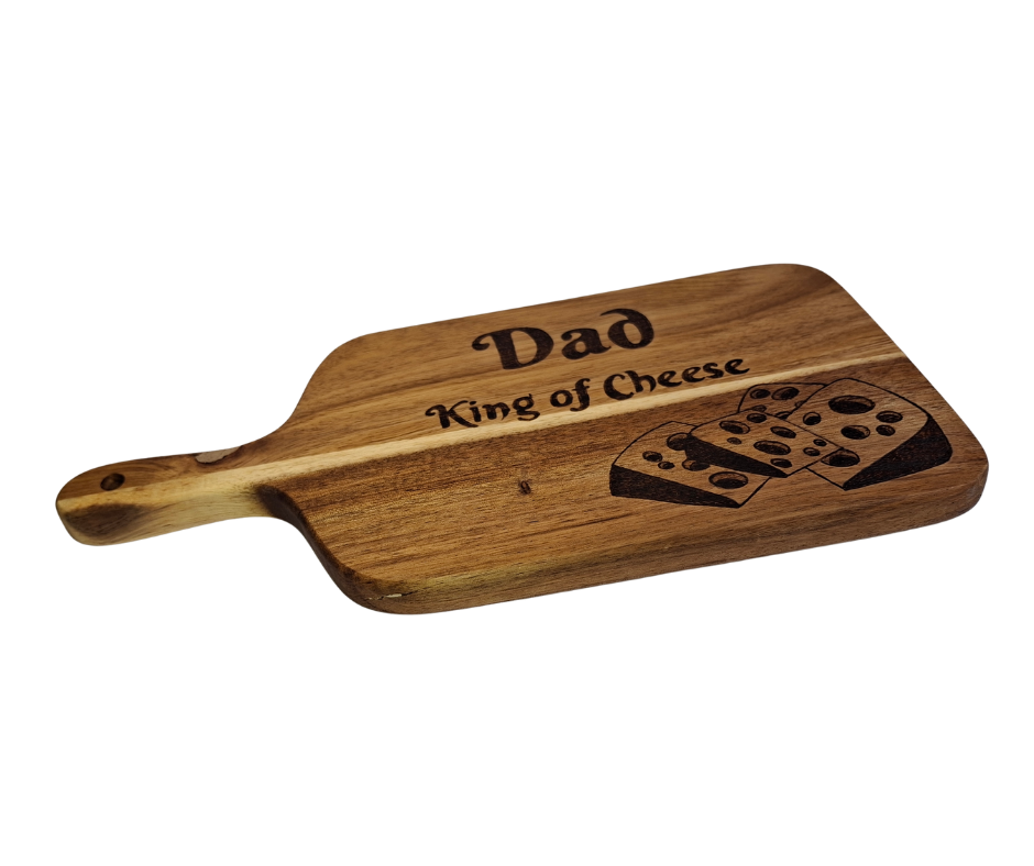 A multicolored, hand-decorated pyrography chopping board with the words "Dad King of Cheese" and illustrations of cheese chunks.