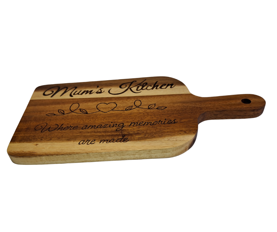 A multicolored, hand-decorated pyrography chopping board with the words "Mum's Kitchen where amazing memories are made" and a heart divider.