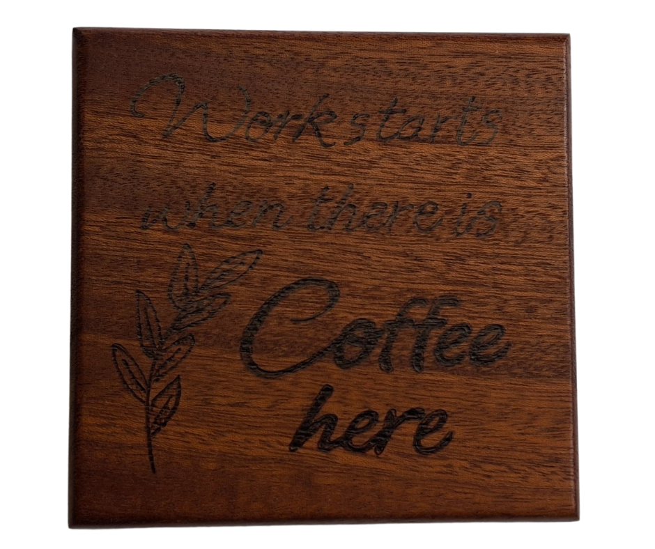Sapele coaster with chamfered edges inscription "Work starts when there is coffee here" burnt in