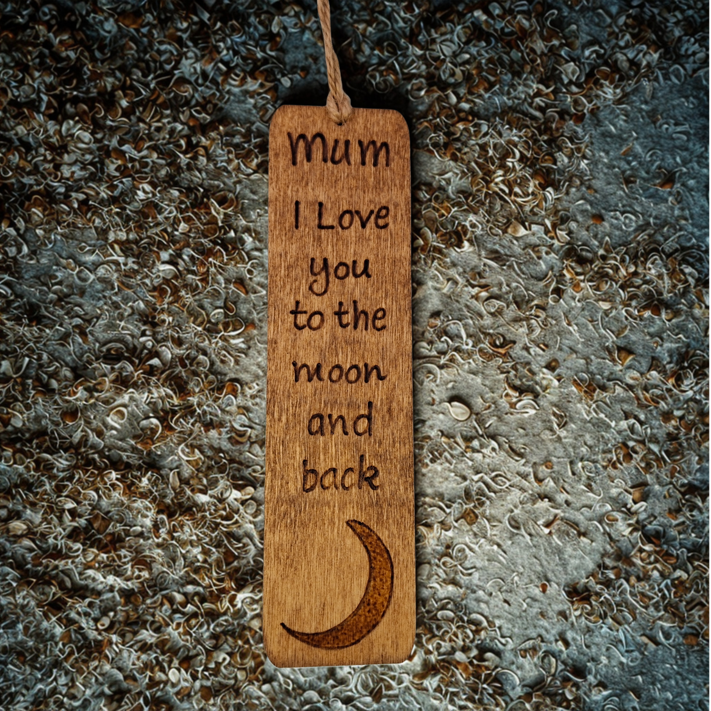Dark wood bookmark with "Mum I love you to the moon and back" pyrography and a moon illustration.