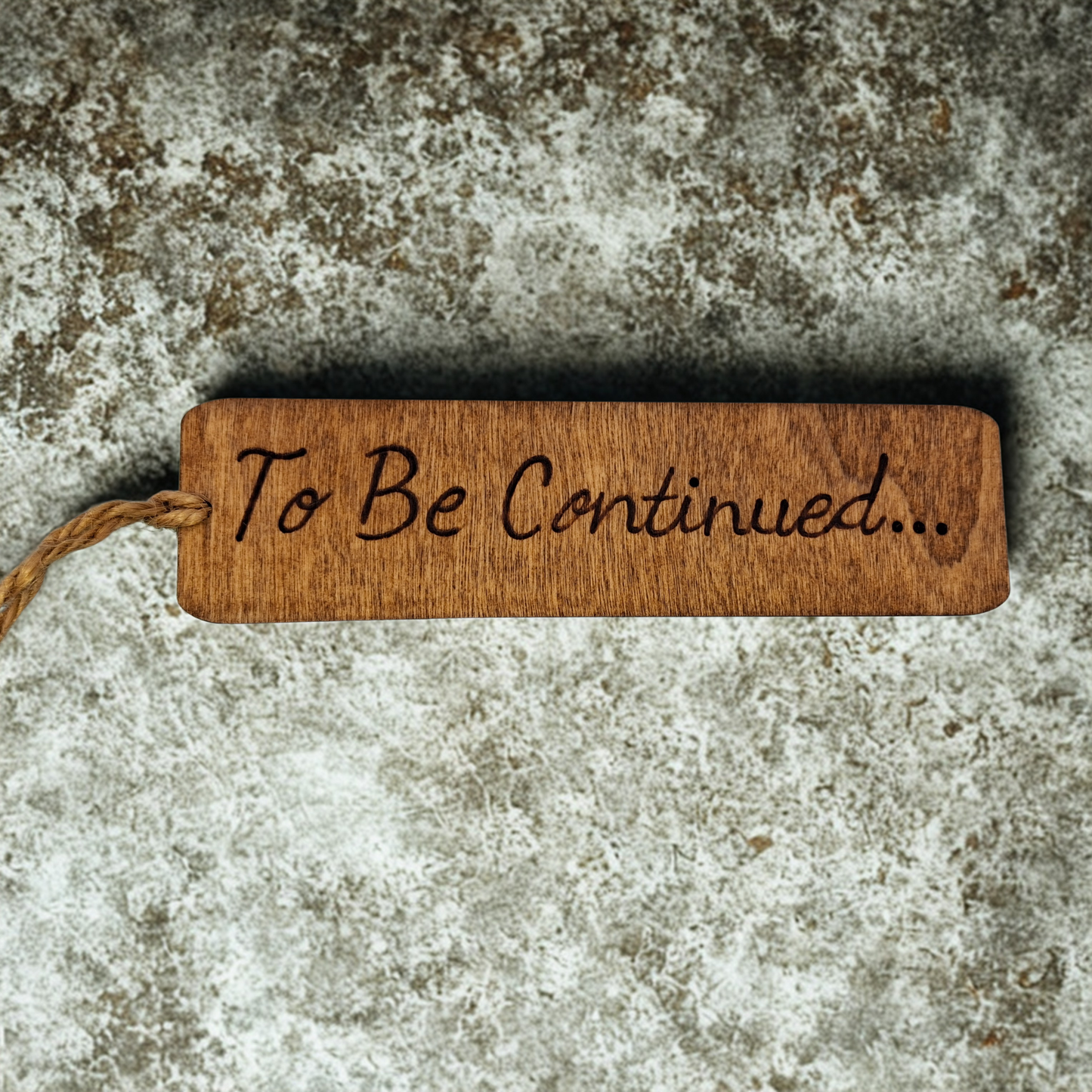 Dark wood bookmark with "To Be Continued..." pyrography.