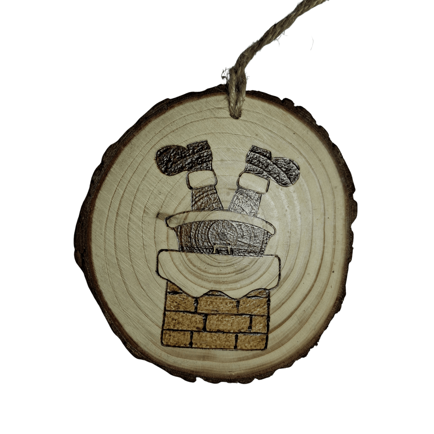 A round wooden Christmas ornament with a jute rope for hanging, centered against a black background. The ornament is decorated with a pyrography design of Santa Claus's legs and boots sticking out of a brick chimney.