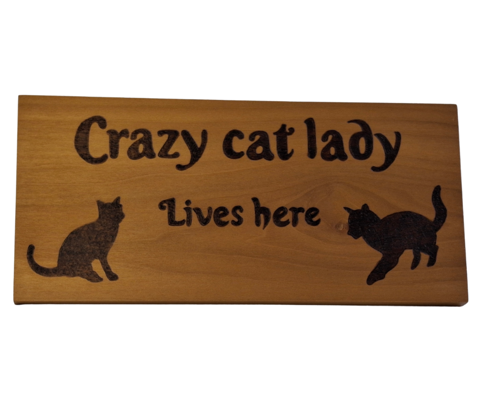 Decorative wooden plaque for cat enthusiasts, intricately hand-decorated with "Crazy Cat Lady Lives Here" lettering and two distinct cat silhouettes.