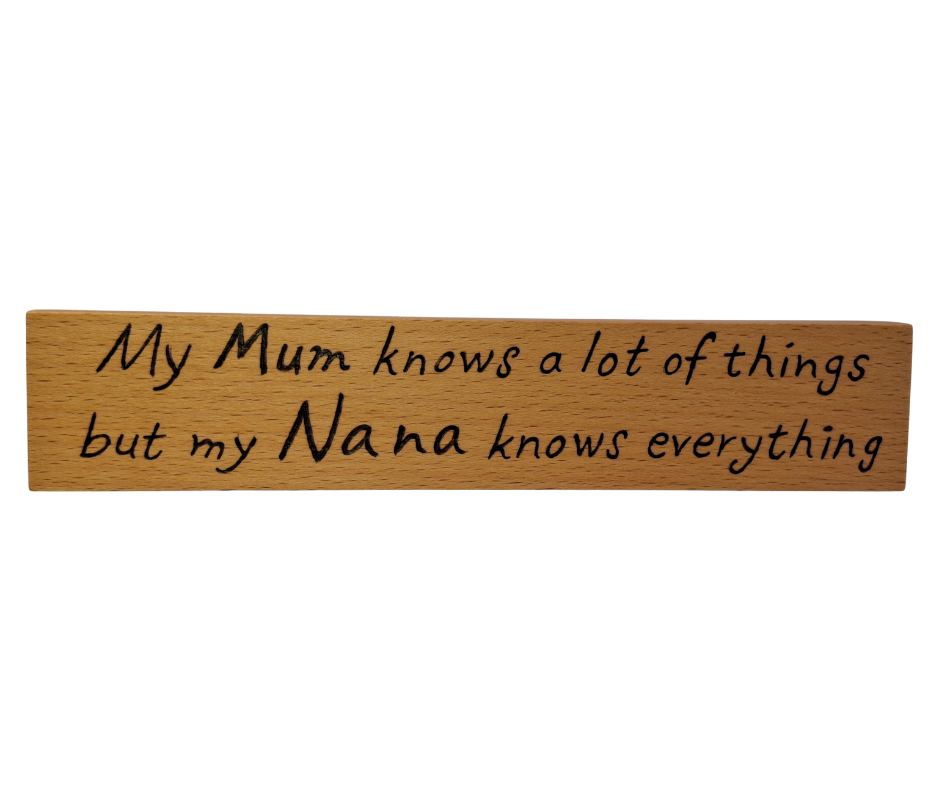 A hand-burnt, freestanding wooden plaque with the words "My Mum knows most things but my Nana knows everything" in a casual, handwritten style. The wood has visible grain and a rustic, natural finish.