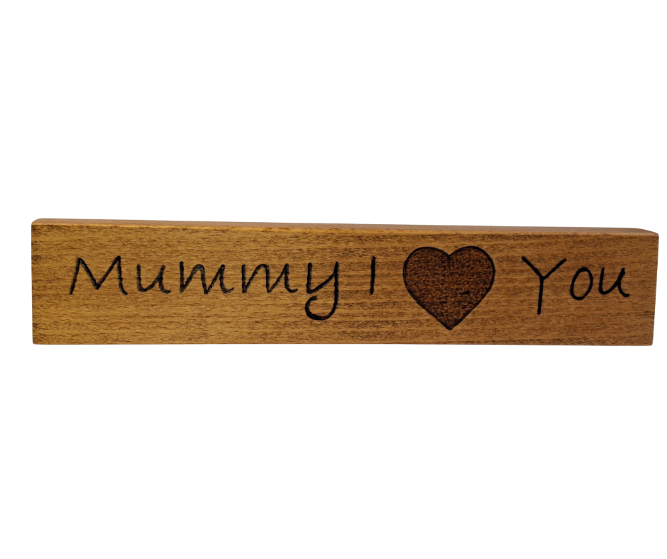 Decorative wooden desktop sign, intricately hand-decorated with the affectionate phrase "Mummy I Love You," where a heart replaces the word 'love'.
