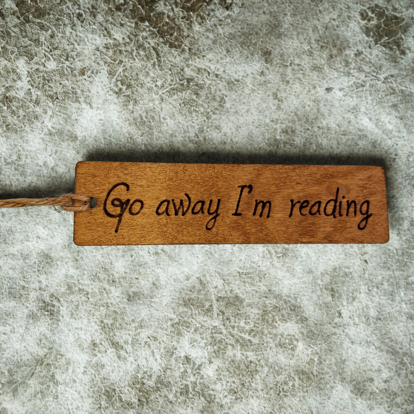 Dark wood bookmark with "Go away I'm reading" pyrography.