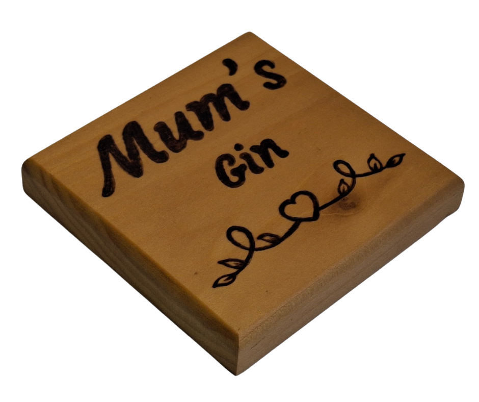 Tulipwood coaster with chamfered edges inscription "Mum's Gin" with a decorative heart pattern burnt onto the wood