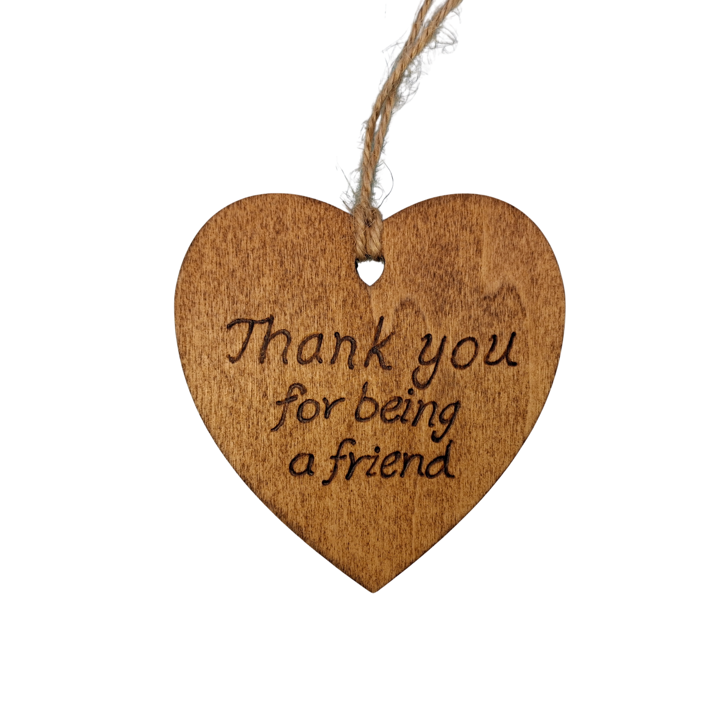 Heart-shaped wooden ornament, hand-drawn with pyrography, featuring the engraved phrase "Thank you for being a friend" in a decorative script, set against a light, plain background.