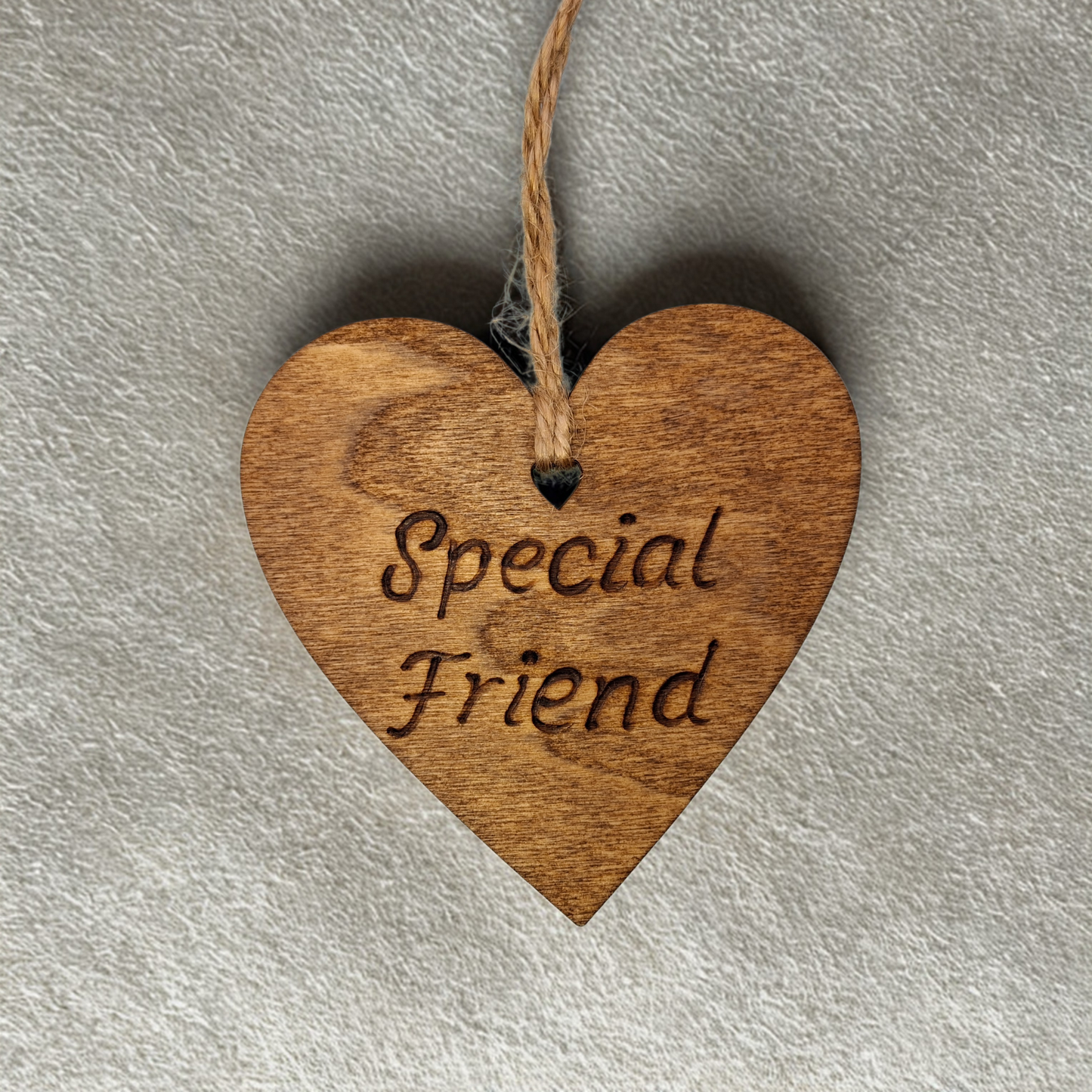 Heart-shaped wooden ornament, hand-drawn with pyrography, featuring the engraved phrase "Special Friend" in a decorative script, set against a light, plain background.