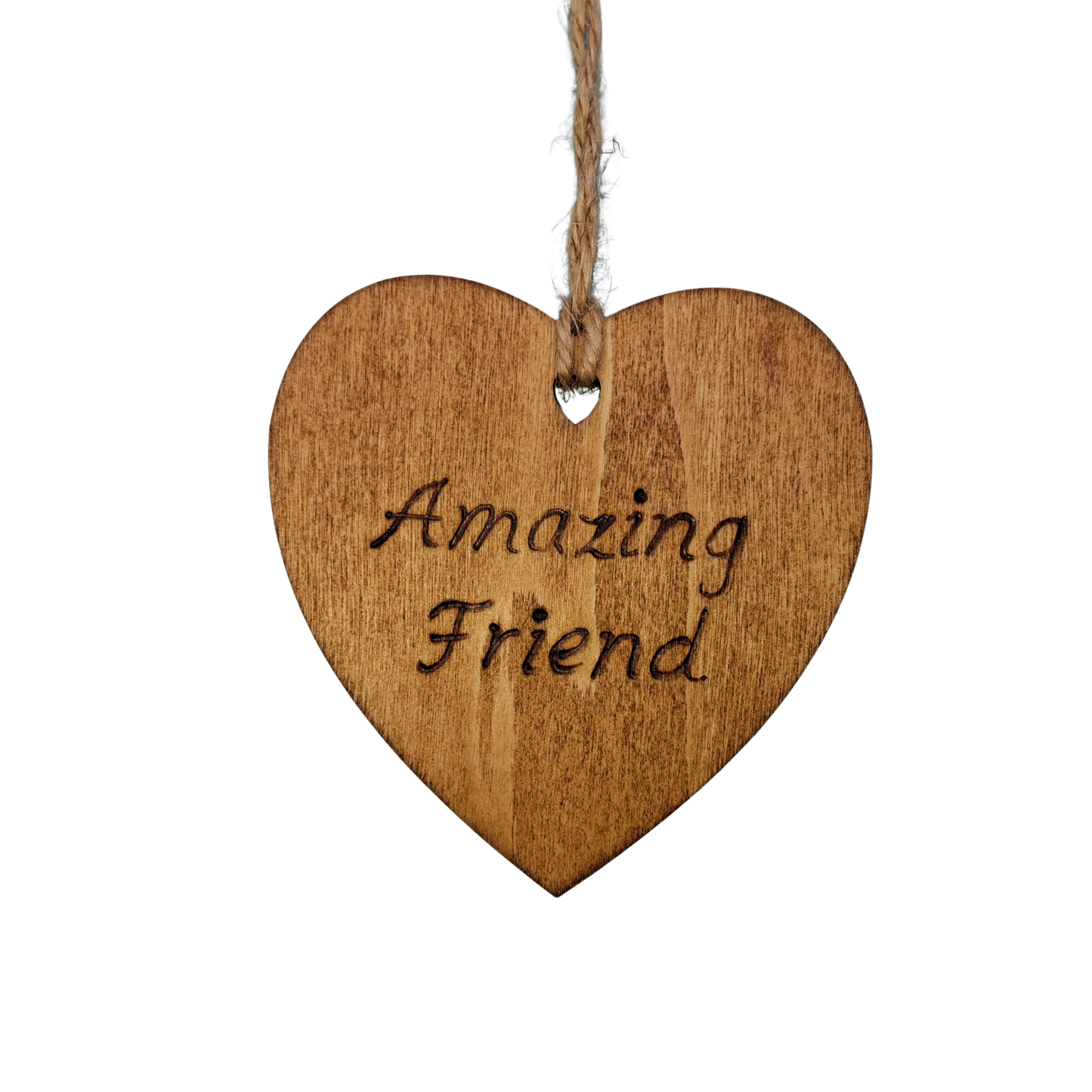 Heart-shaped wooden ornament, hand-drawn with pyrography, featuring the engraved phrase "Amazing Friend" in a decorative script, set against a light.