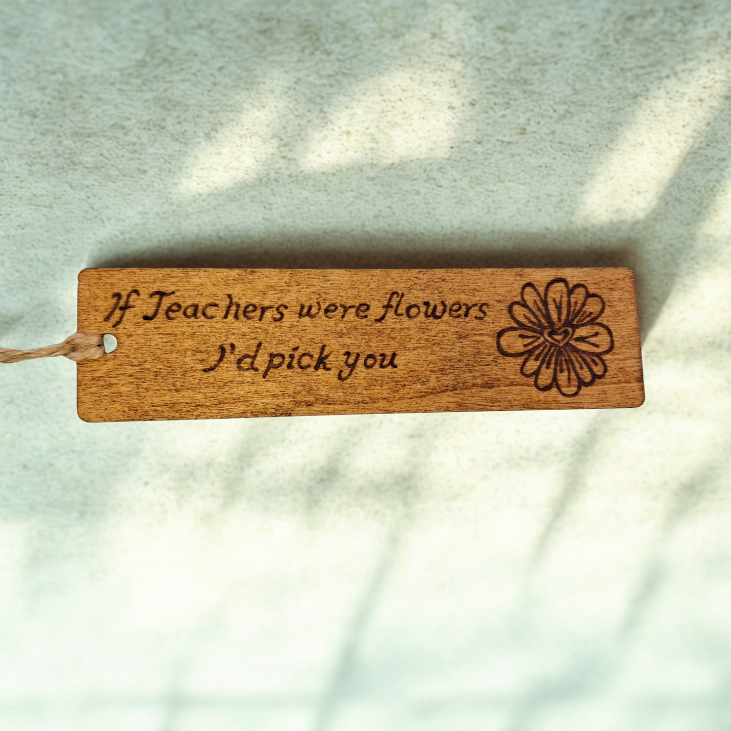 Dark wood bookmark with "If Teachers were flowers I'd pick you" pyrography and a flower head illustration.