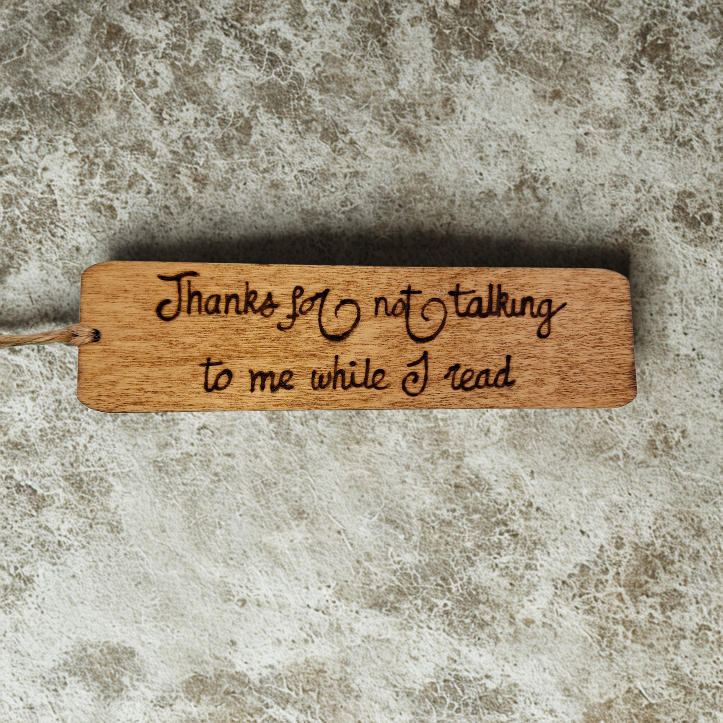 Dark wood bookmark with "Thanks for not talking to me while I read" pyrography.