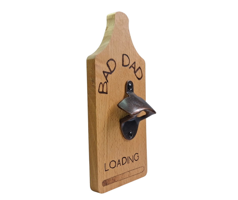 Decorative wall-mounted Beechwood bottle opener with a rustic metal opener, intricately hand-decorated with "Bad Dad... Loading" text