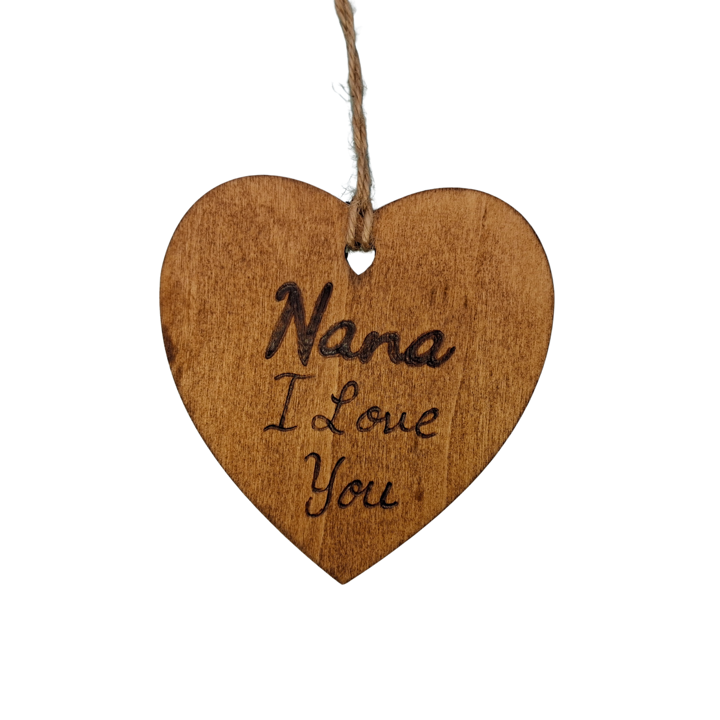 Heart-shaped wooden ornament, hand-drawn with pyrography, featuring the engraved phrase "Nana I Love You" in a decorative script, set against a textured background.