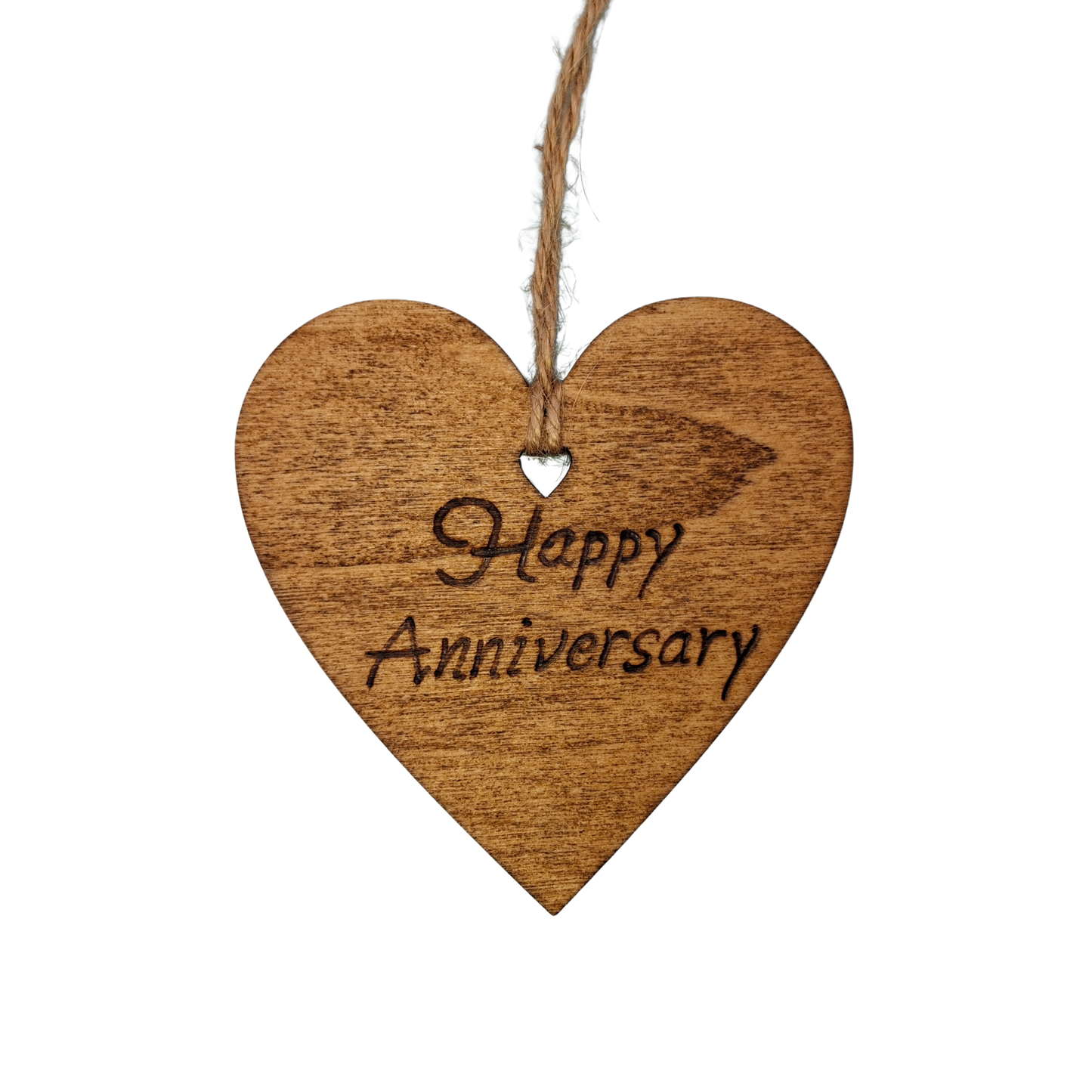 Heart-shaped wooden ornament, hand-drawn with pyrography, featuring the engraved phrase "Happy Anniversary" in a decorative script, set against a light, plain background.