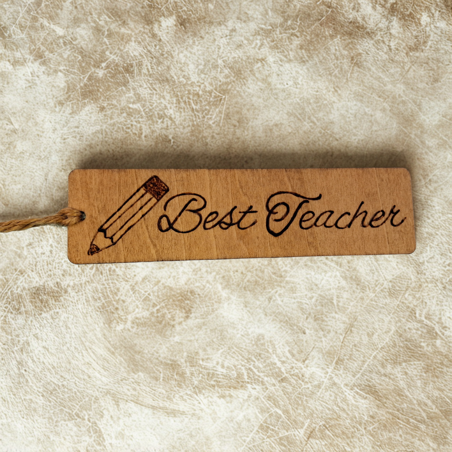 Dark wood bookmark with "Best Teacher" pyrography and a pencil illustration.