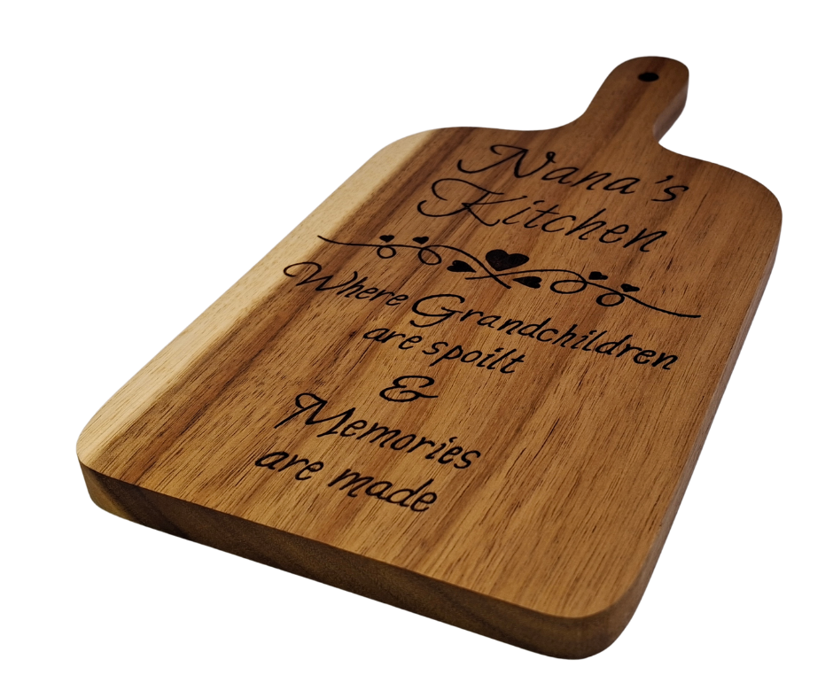 A multicolored, hand-decorated pyrography chopping board with the words "Nana's Kitchen where grandchildren are spoilt and memories are more" and a decorative heart divider.