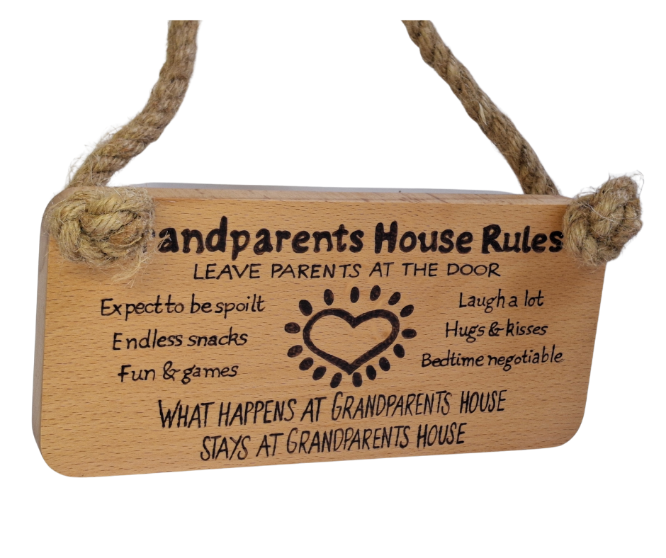 Hand-decorated pyrography sign for grandparents, featuring "Grandparents House Rules" and playful guidelines such as "Leave parents at the door," suspended by a sturdy jute rope.
