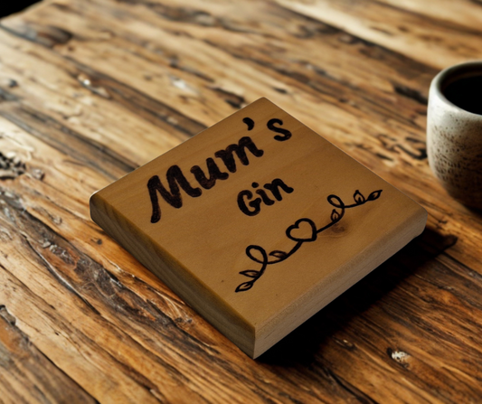 Tulipwood coaster with chamfered edges inscription "Mum's Gin" with a decorative heart pattern burnt onto the wood