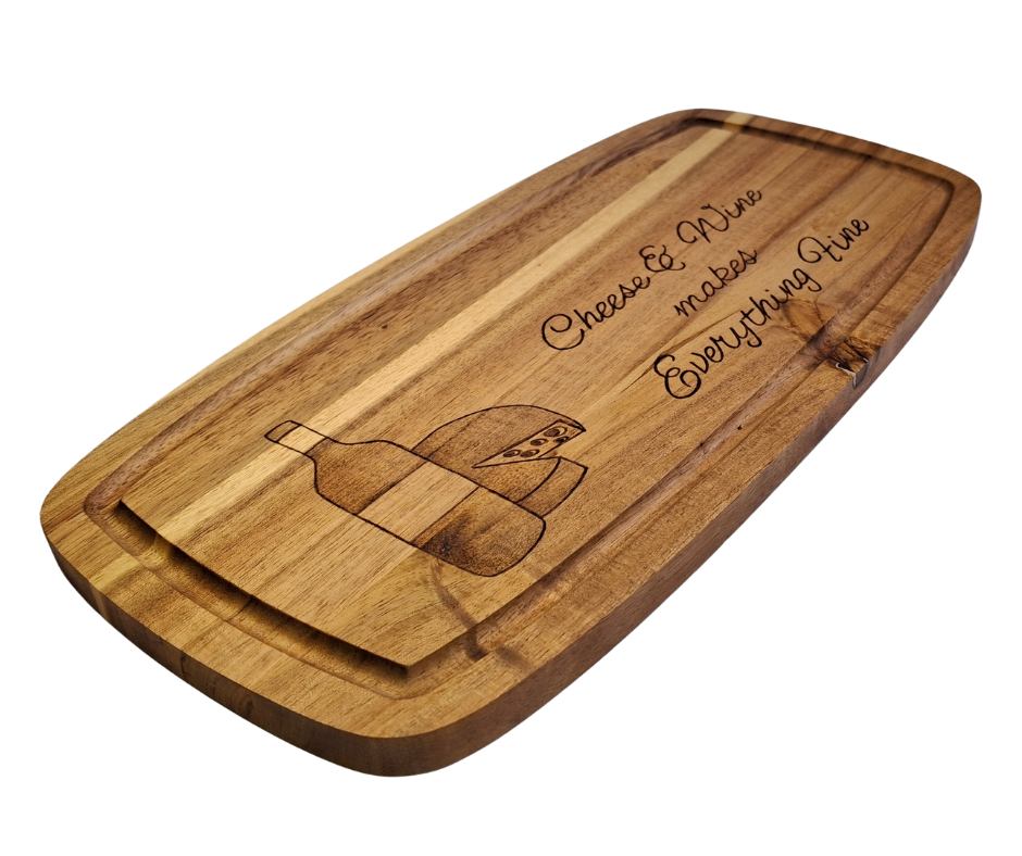 A multicolored, hand-decorated pyrography chopping board with the words "Cheese and Wine Makes Everything Fine," illustrated with a bottle of wine and a partial wheel of cheese