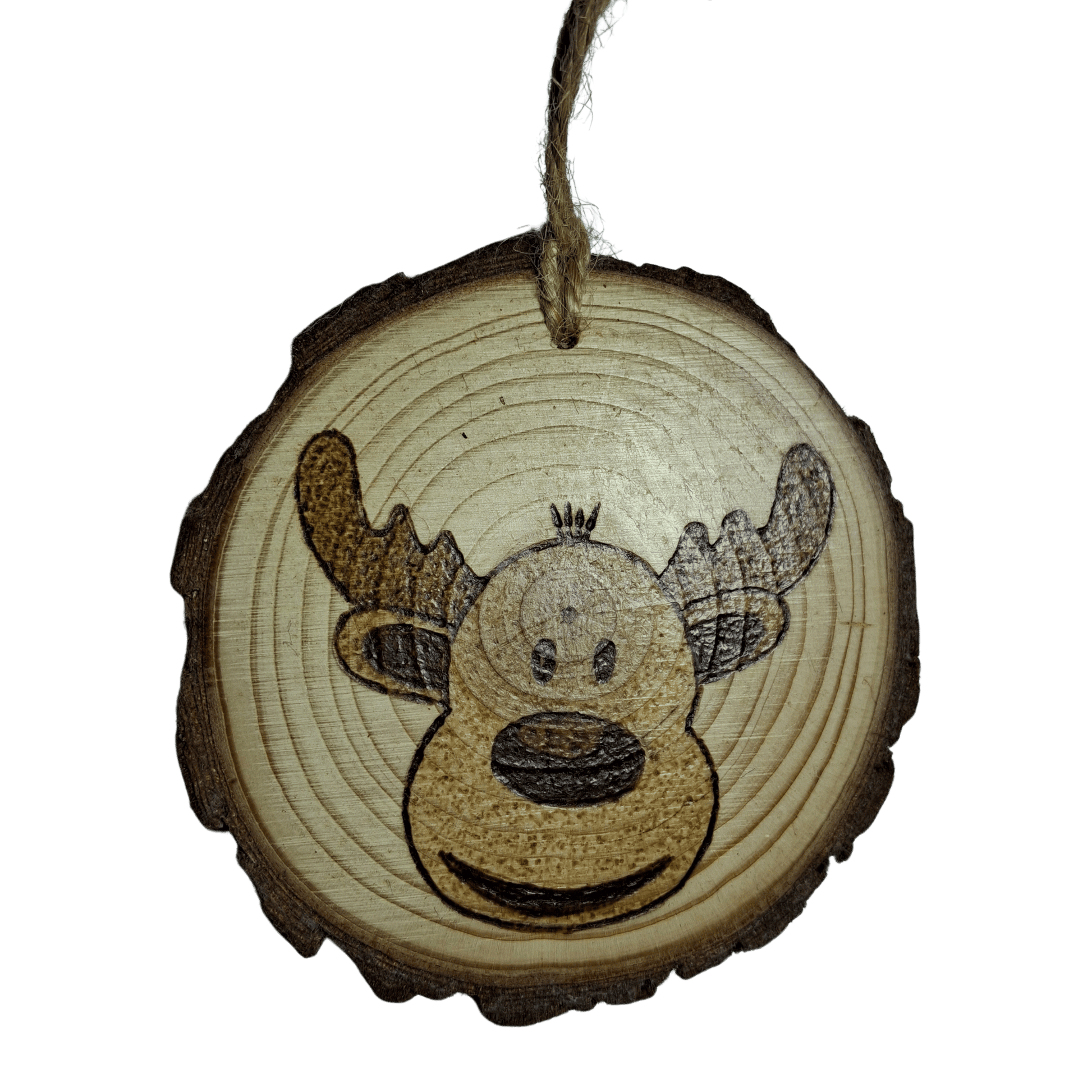 
A close-up of a Christmas ornament on a black background. The ornament is a round wooden log slice with a jute rope for hanging. The front of the ornament is decorated with a pyrography design of a smiling cartoon reindeer with large antlers.
