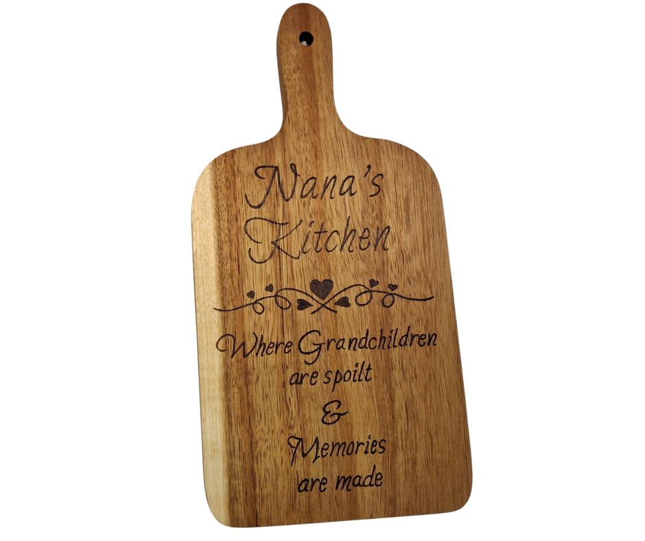 A multicolored, hand-decorated pyrography chopping board with the words "Nana's Kitchen where grandchildren are spoilt and memories are more" and a decorative heart divider.