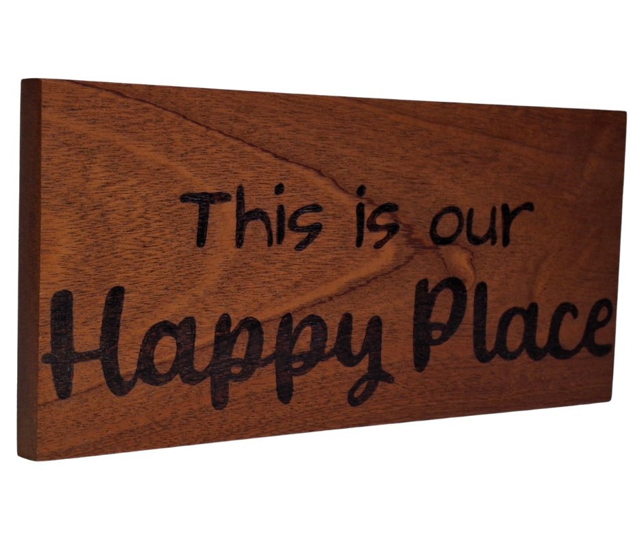 Hand-burnt wooden sign featuring the heartfelt "This is our Happy Place" message.