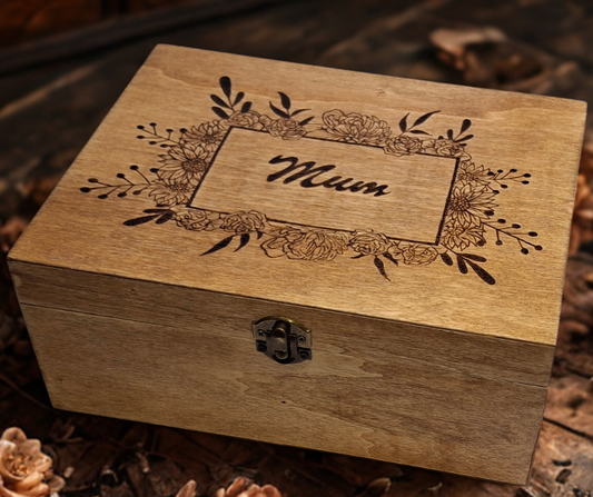 Wooden box with "Mum" hand-burnt inside a square frame, surrounded by Poinsettia flowers