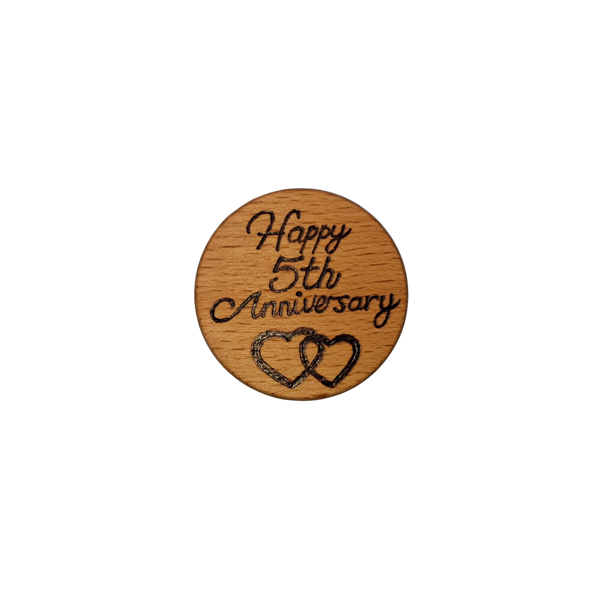 Close-up of a light-colored beechwood circle, 5cm in diameter and 0.4cm thick, featuring the words "Happy 5th Anniversary" and an illustration of 2 hearts hand-burned into its surface using pyrography. The wood has a smooth, waxed finish and the text is clearly legible.