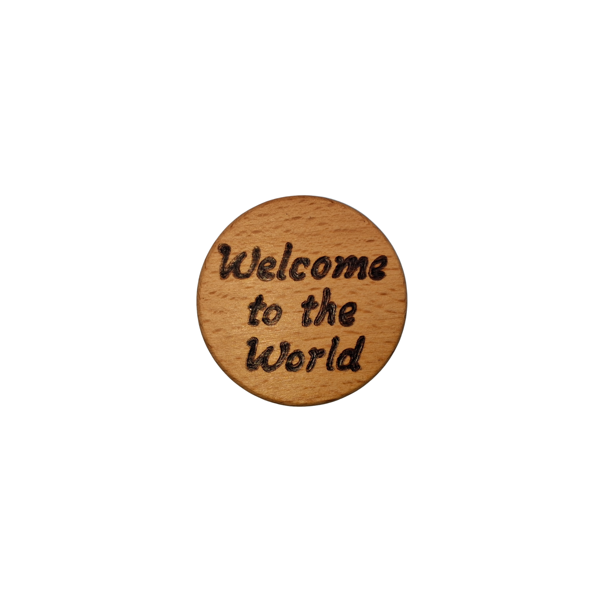 Close-up of a light-colored beechwood circle, 5cm in diameter and 0.4cm thick, featuring the words "Welcome to the world" hand-burned into its surface using pyrography. The wood has a smooth, waxed finish and the text is clearly legible.