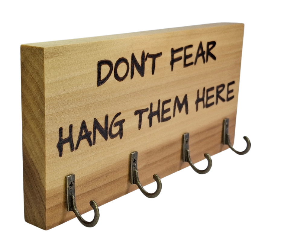  four-hook hanger crafted from two-tone Tulipwood, featuring hand-burnt lettering that reads "Don't Fear Hang Them Here." The wood has visible grain, showcasing its natural variations.