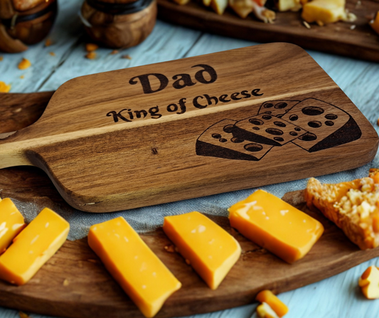 A multicolored, hand-decorated pyrography chopping board with the words "Dad King of Cheese" and illustrations of cheese chunks.