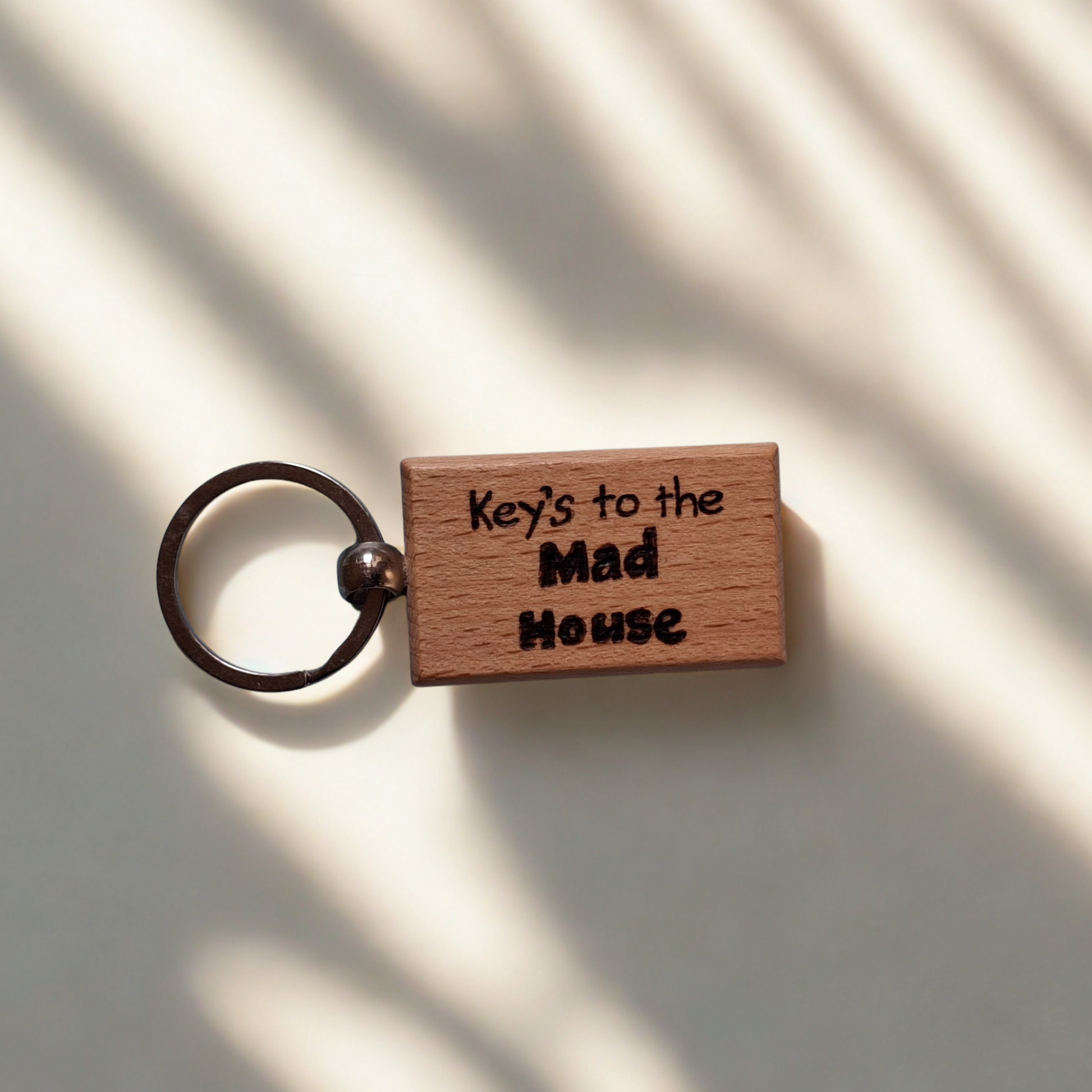 Rectangle beechwood keyring with 'Key's to the Mad House' pyrography text and chrome split ring
