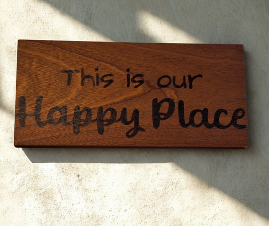 Wooden plaque hand-decorated with "This is our Happy Place" pyrography.