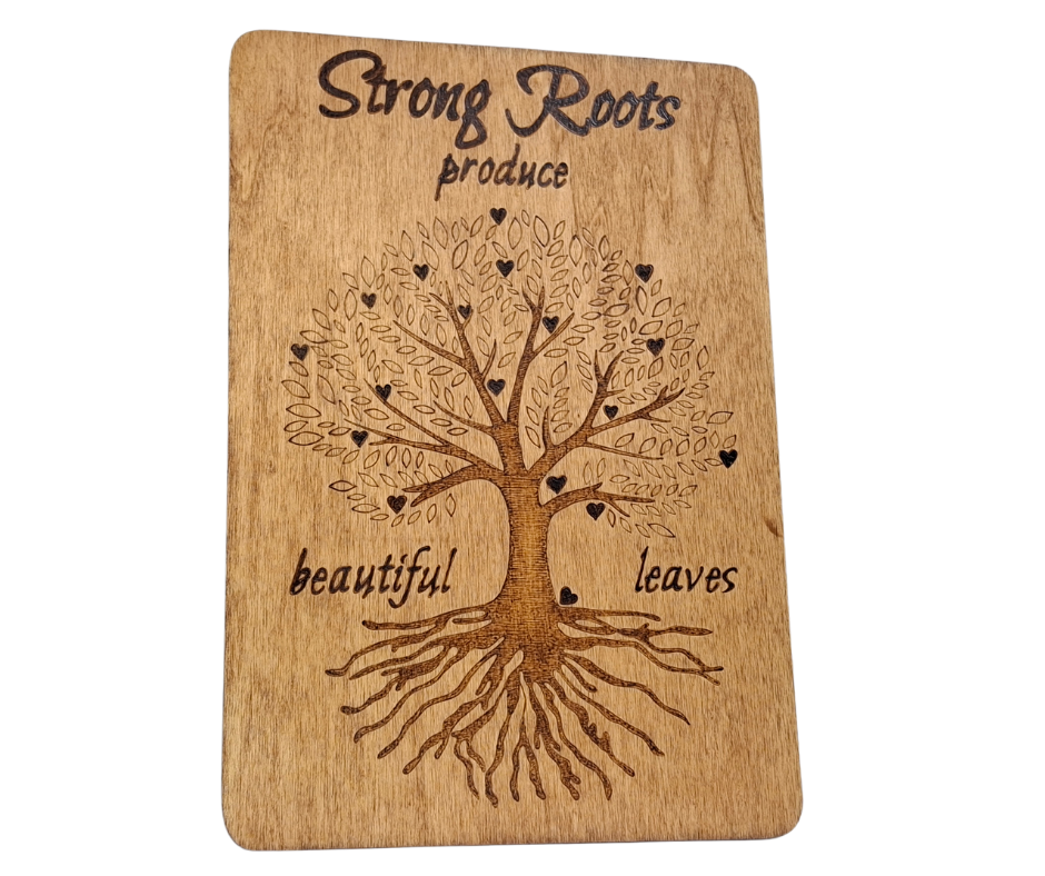 Decorative wooden plaque for family or heritage, intricately hand-decorated with "Strong Roots Produce Beautiful Leaves" text and a large, symbolic tree bearing heart-shaped leaves