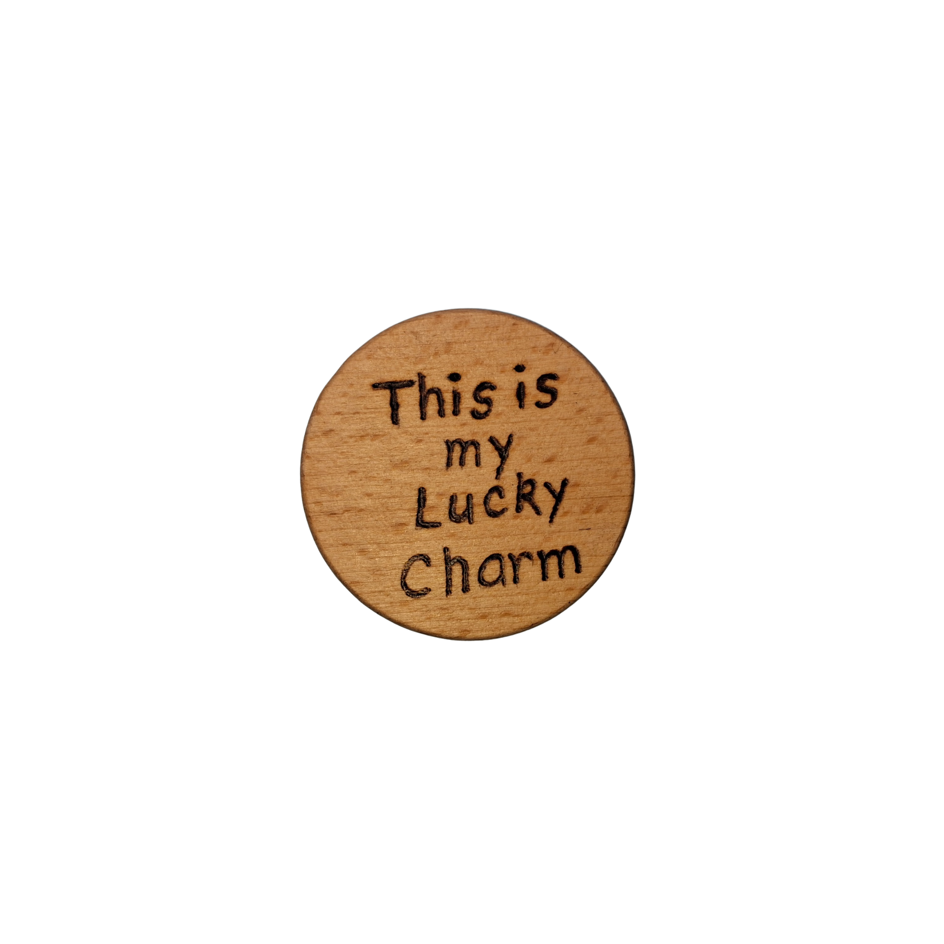 Close-up of a light-colored beechwood circle, 5cm in diameter and 0.4cm thick, featuring the words "This is my Lucky charm" hand-burned into its surface using pyrography. The wood has a smooth, waxed finish and the text is clearly legible.