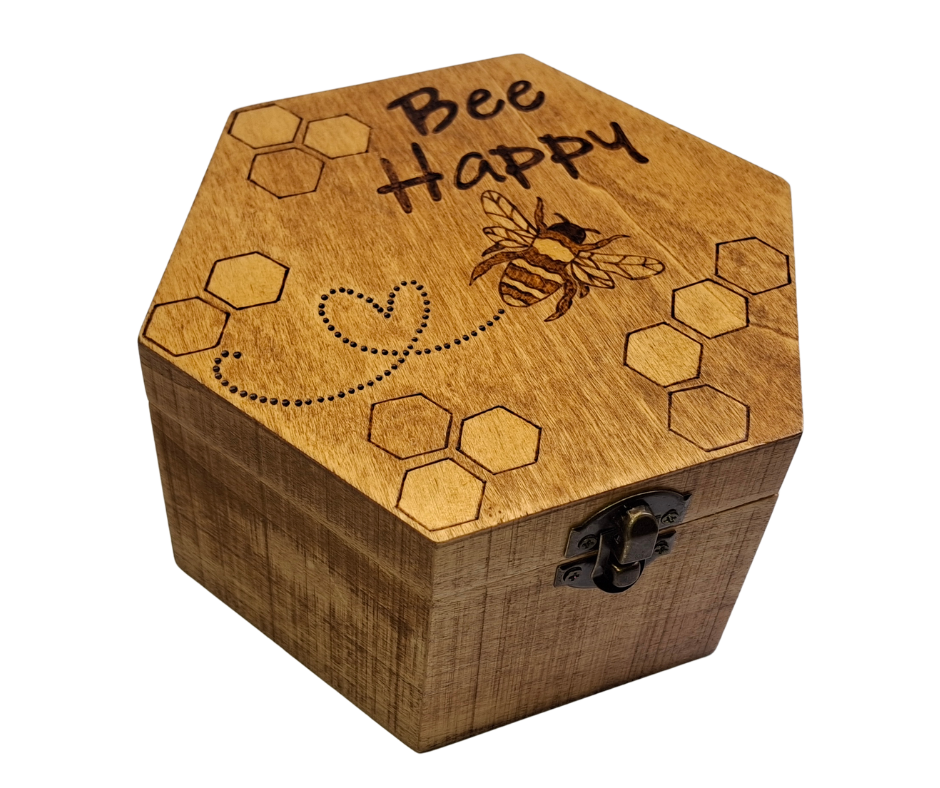 Box with "Bee Happy" a picture of a bee, leaving a heart trail and hexagons, burnt into the wood